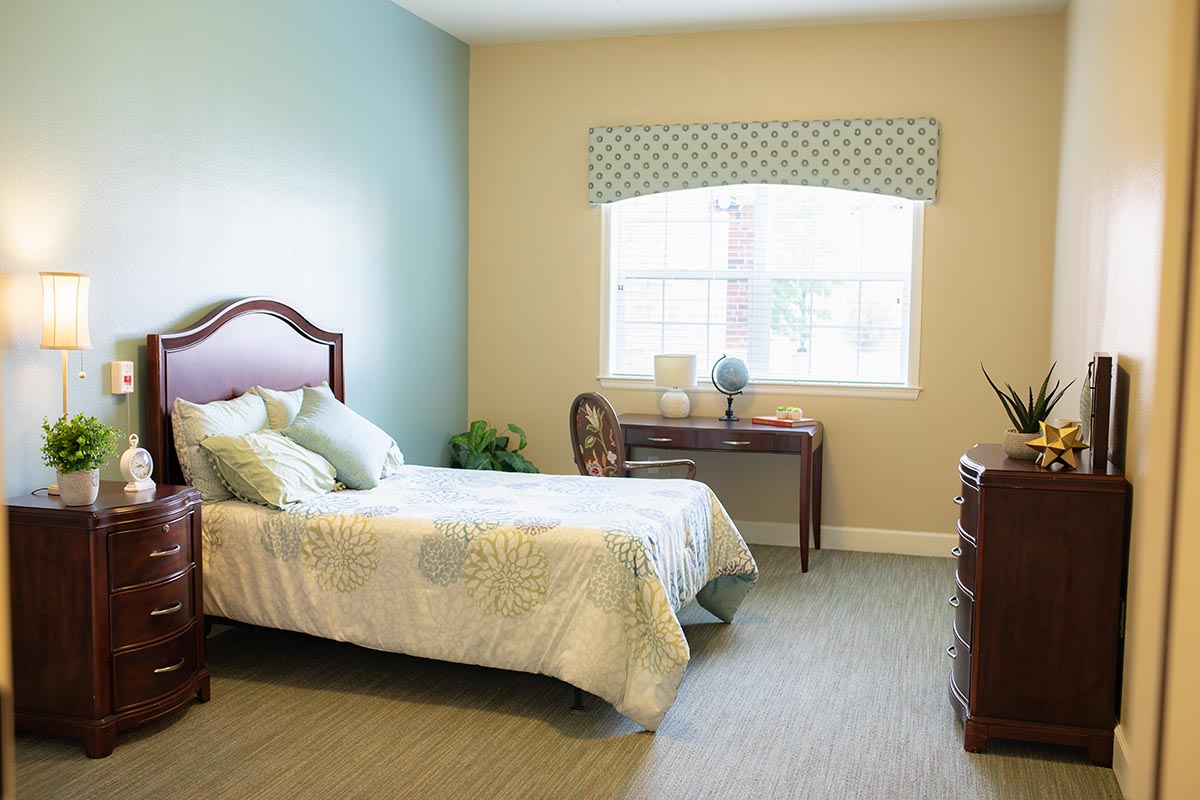 Jasmine Estates of Edmond | Empty one person bedroom with a nice bed and window