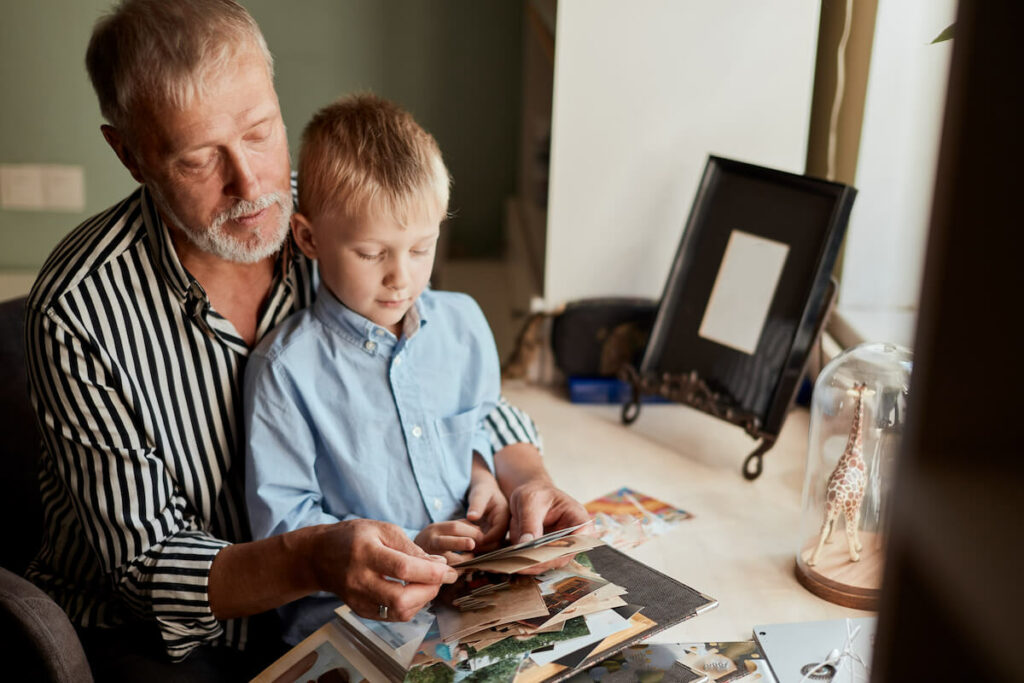 Jasmine Estates of Oklahoma City | Senior man and his grandson looking through photos